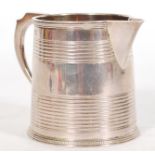 WITHDRAWN FROM SALE A 19th century Georgian silver hallmarked jug having a ribbed and beaded