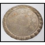 A Persian Islamic silver white metal tray, with an embossed floral design with medallions and