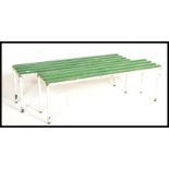 A pair of vintage 20th century Lilo / Tennis sports benches, raised on a metal tubular frame