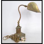 A good 20th century brass bankers desk lamp raised on a terraced square base with adjustable neck