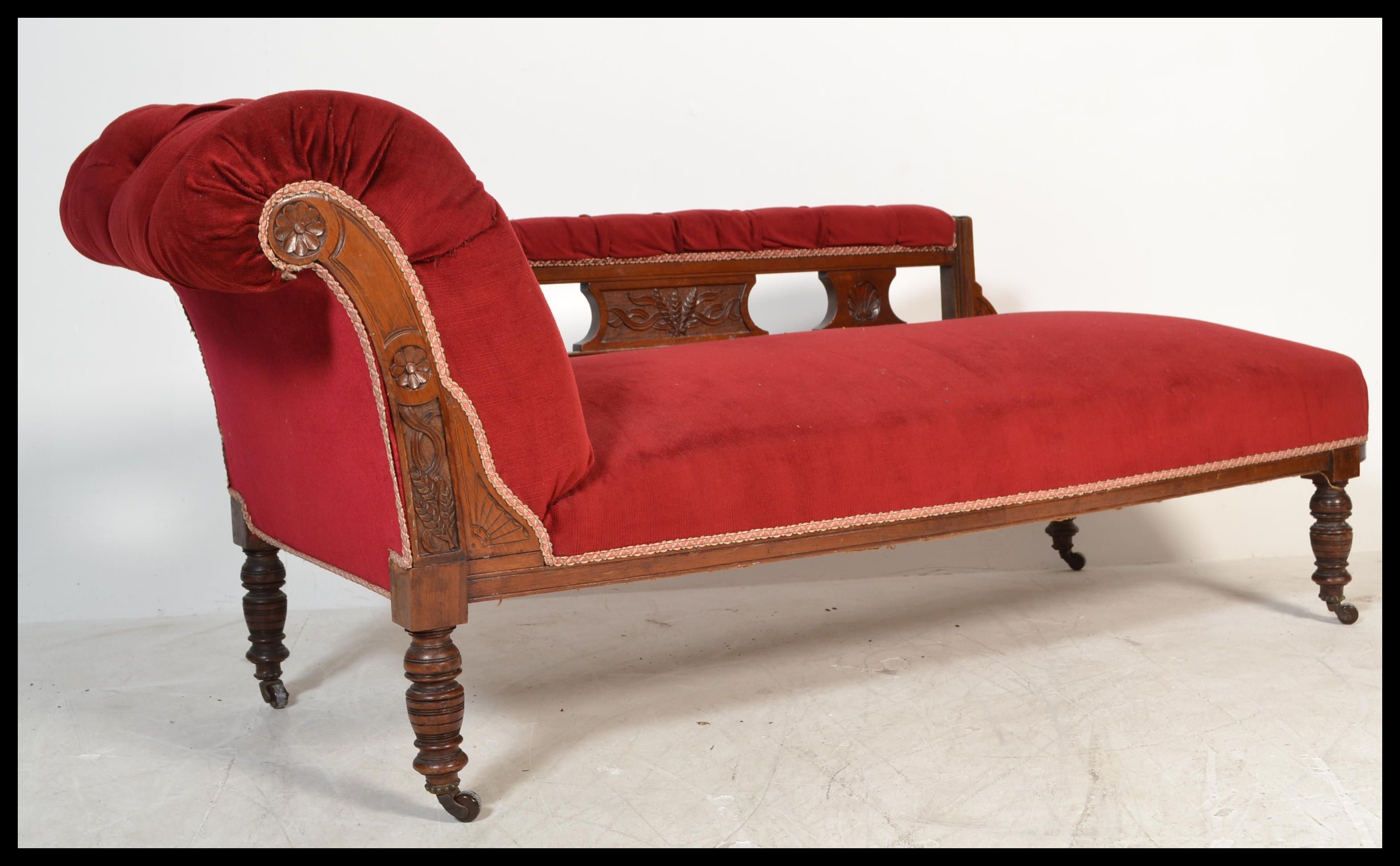 An early 20th Century Edwardian chaise lounge with upholstered button back seat, scrolled back and