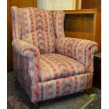 A good 19th century Victorian wing back armchair in the manner of Howard & Son. Raised on mahogany