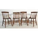 A set of four 19th century Victorian Windsor elm and beech stick back dining chairs having solid elm