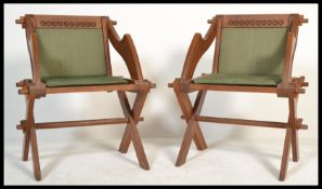 A pair of Victorian 19th century oak Glastonbury chairs in solid oak with velour padded seats and