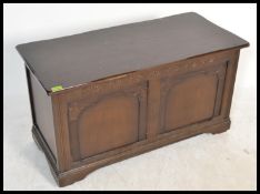 A vintage 20th Century oak Jacobean revival blanket box, panel front and sides,hinged top raised