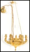 A 19th century ormolu classical chandelier modeled on a hanging oil lamp having decorative lion