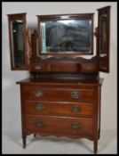 An Edwardian mahogany arts & crafts batwing dressing table chest of drawers. The chest with a series