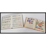 A collection of stamp albums containing stamps dating from the 19th century including penny reds.