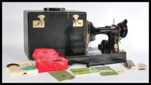 A vintage 20th century Singer Featherweight convertible portable sewing machine model number 222k