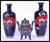 A group of cloisonne wares to include a pair of Japanese cloisonne vases and a brass and cloisonne