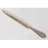 A silver hallmarked letter opener of larger form having shaped handle with engraved design. Weighs