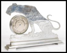 A 20th century vintage retro silver metal barometer in the form of a tiger reading 'Stormy, Rain,