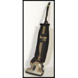 A vintage Hoover Junior suction sweeper, with the