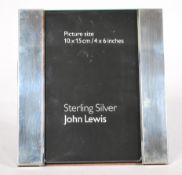 A silver hallmarked John Lewis easel back picture