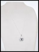 A 20th century silver pendant necklace featuring t