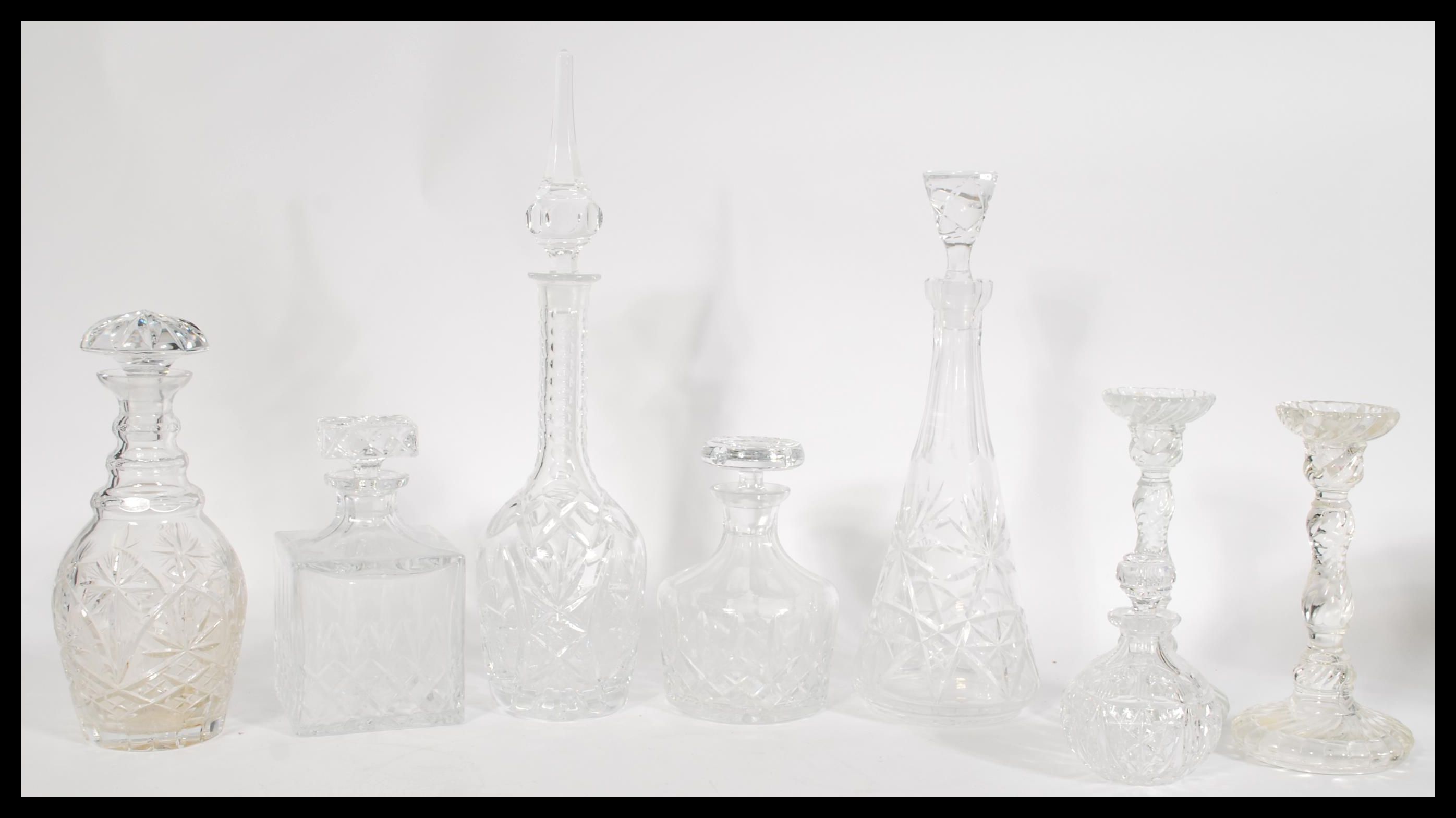 A collection of cut glass crystal decanters and ca