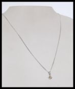 A 20th century 18ct white gold pendant necklace wi
