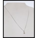 A 20th century 18ct white gold pendant necklace wi