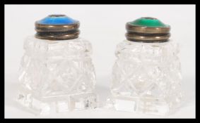 A pair of early 20th century small cut glass jars