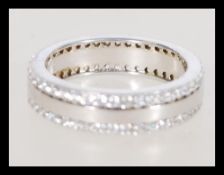 A 20th century silver eternity ring with inset cub
