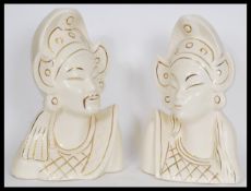 A pair of Asiatic white ceramic bust figures depic