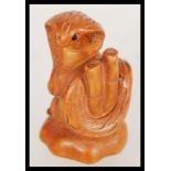 A wooden netsuke figurine in the form of a cobra s