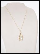 A baroque pearl pendant necklace set into a 9ct Bi