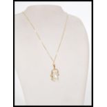 A baroque pearl pendant necklace set into a 9ct Bi