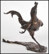 A bronze figure of a running rooster on a modeled base by Lucy Kinsella, signed 'Kinsella' to the