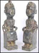 A pair of large unusual cast bronze African tribal statue / figurines. Each of seated religious