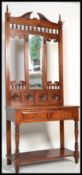 A Victorian style hardwood hall stand with upright mirror back having glove drawer to the centre and