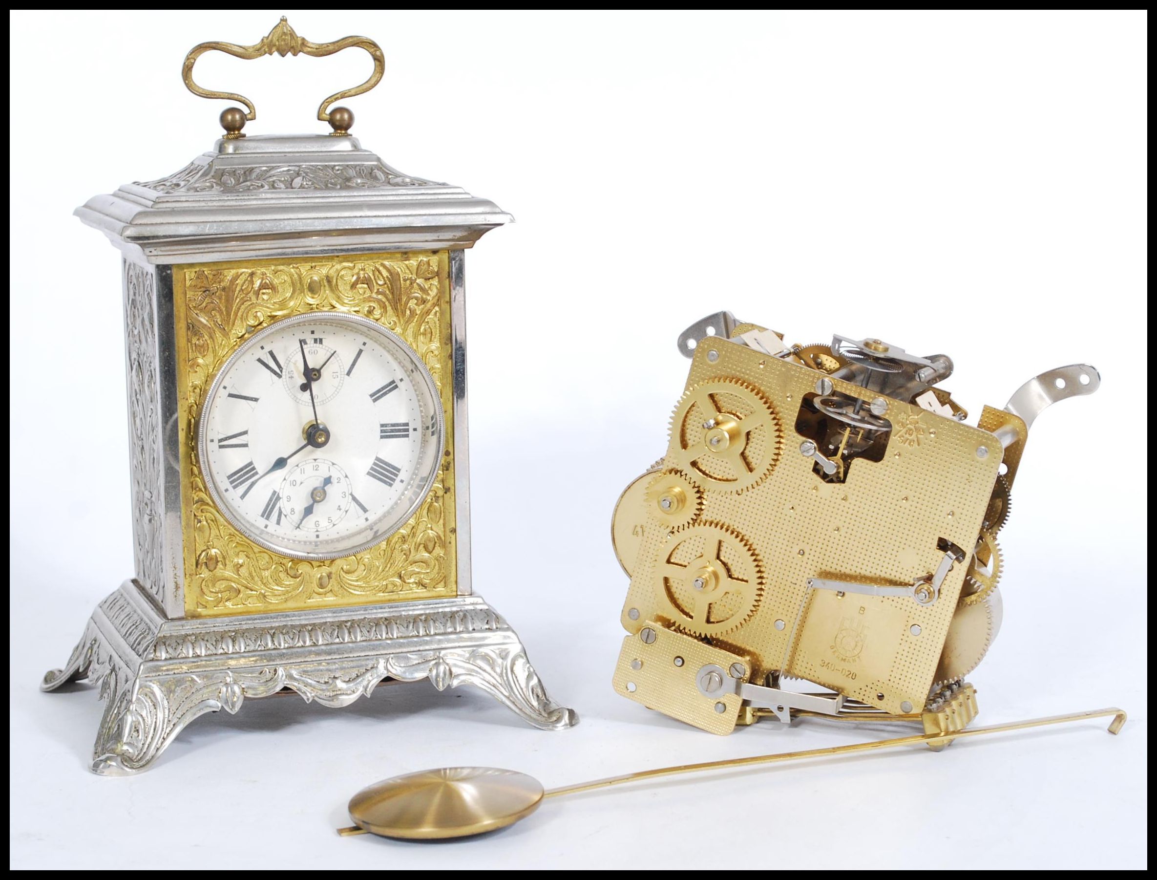 A vintage 20th Century pressed bracket clock, the case pressed with classical scenes together with a