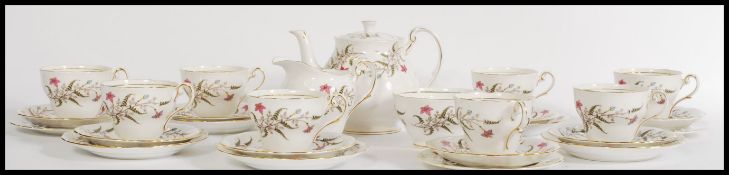 A vintage 20th century eight person fine English bone china tea service in the Fancy Free pattern