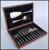 A vintage early 20th century Page Keen & Page Plymouth oak cased canteen of silver plated fish