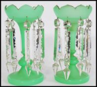 A pair of 19th century Victorian green glass lustres with with crenelated rims, having eight