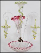 A 19th century Victorian Vaseline glass epergne centerpiece with a large central trumpet with a