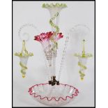 A 19th century Victorian Vaseline glass epergne centerpiece with a large central trumpet with a