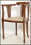 An Edwardian mahogany inlaid corner chair being raised on squared legs with spade feet, pad seat and