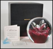 A large 20th century Caithness glass dump paperweight with inset control bubble decoration of