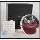 A large 20th century Caithness glass dump paperweight with inset control bubble decoration of