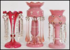 A 19th century Victorian harlequin set of glass lustres, to include a pink glass lustre with a