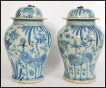 A pair Chinese blue and white large tall lidded vases having hand painted decorated with