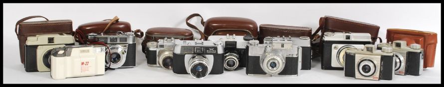 A selection of vintage and leather bound cameras to include a Halina Paulette Electric, a Koroll
