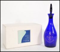 A vintage Bristol Blue glass decanter having crest and notation for the University of Bristol,