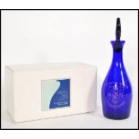 A vintage Bristol Blue glass decanter having crest and notation for the University of Bristol,