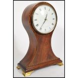 A Comitti of London balloon shaped mahogany clock, Roman numeral chapter dial raised on brass