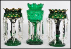 A 19th century Victorian garniture of green glass lustres, to include two matching with with