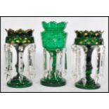 A 19th century Victorian garniture of green glass lustres, to include two matching with with