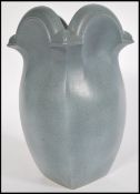 A stunning Gothic revival studio pottery vase of bulbous flared form, the finish giving the affect