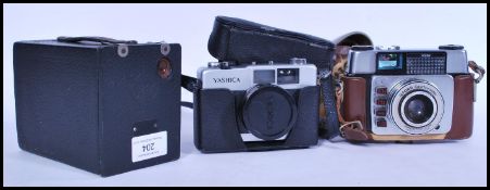 A collection of vintage cameras to include a Kodak box brownie, an Ilford Sportsmaster 35mm and a